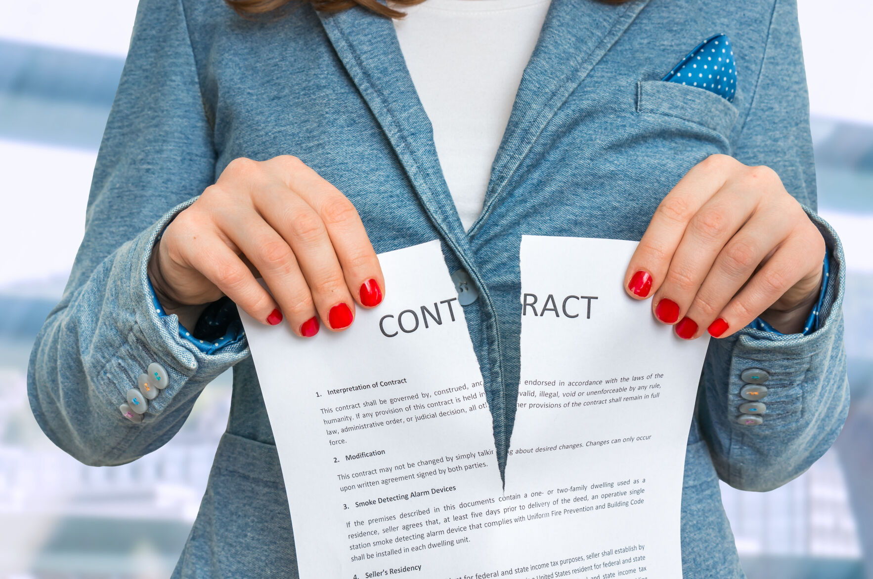 Business woman tearing contract in office